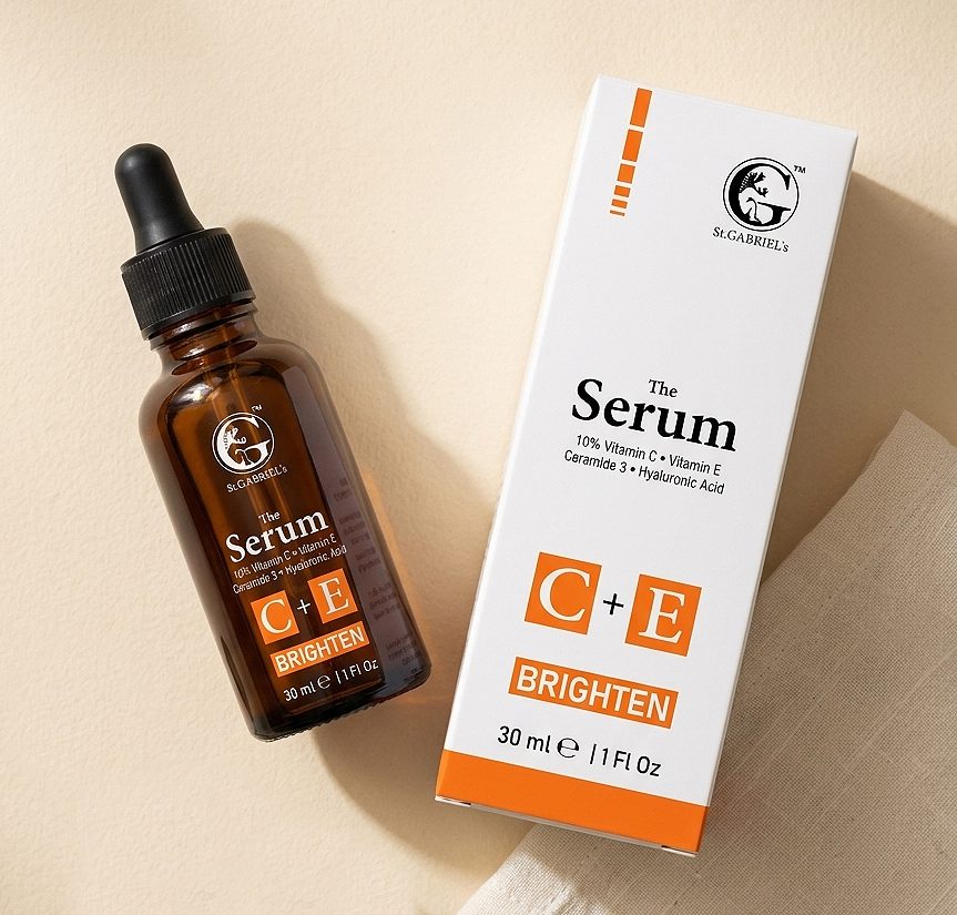 The Serum C+E amber bottle flat lay with eucalyptus and linen