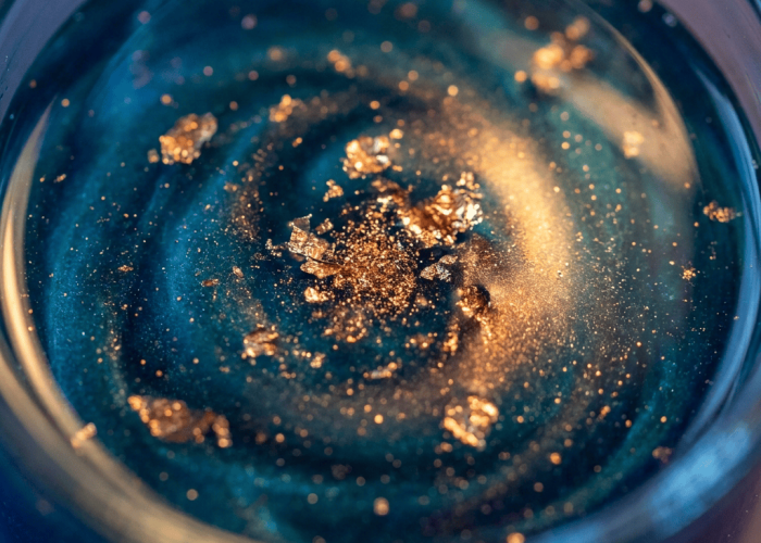 Iridescent copper-blue GHK-Cu tripeptide solution in small glass vial